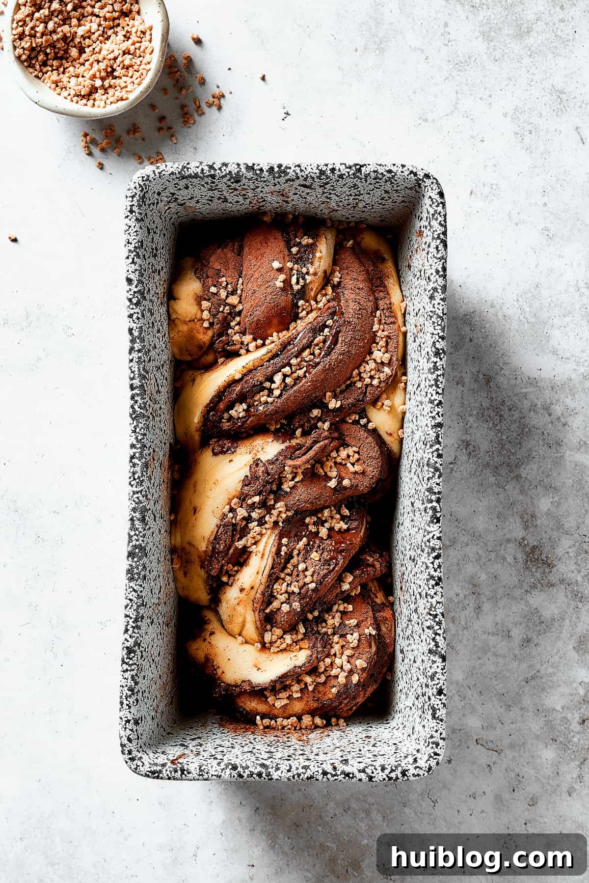 Twisted lengths of chocolate-filled dough placed in a loaf pan.
