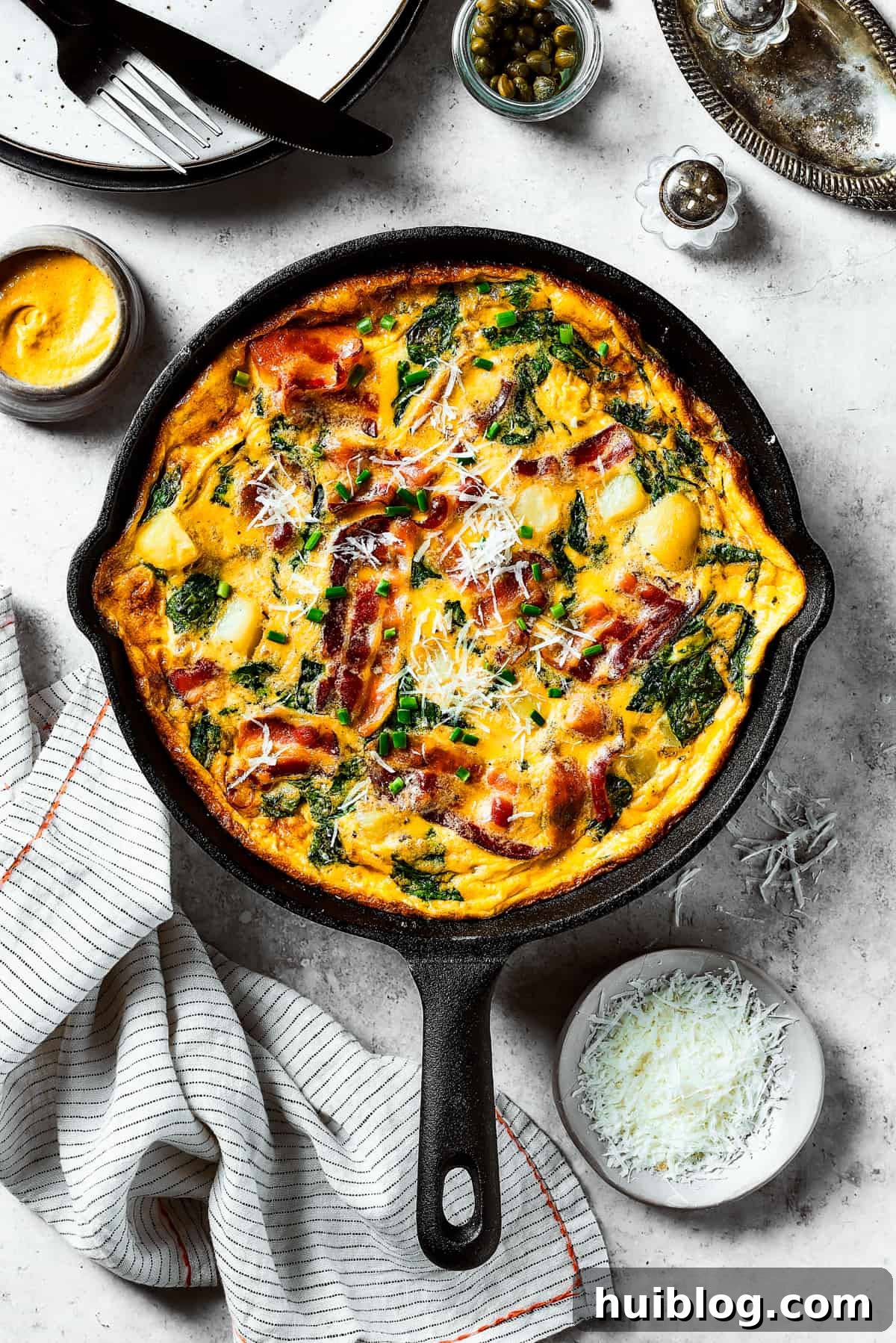A fully-cooked, golden-brown frittata perfectly set in a cast-iron skillet.