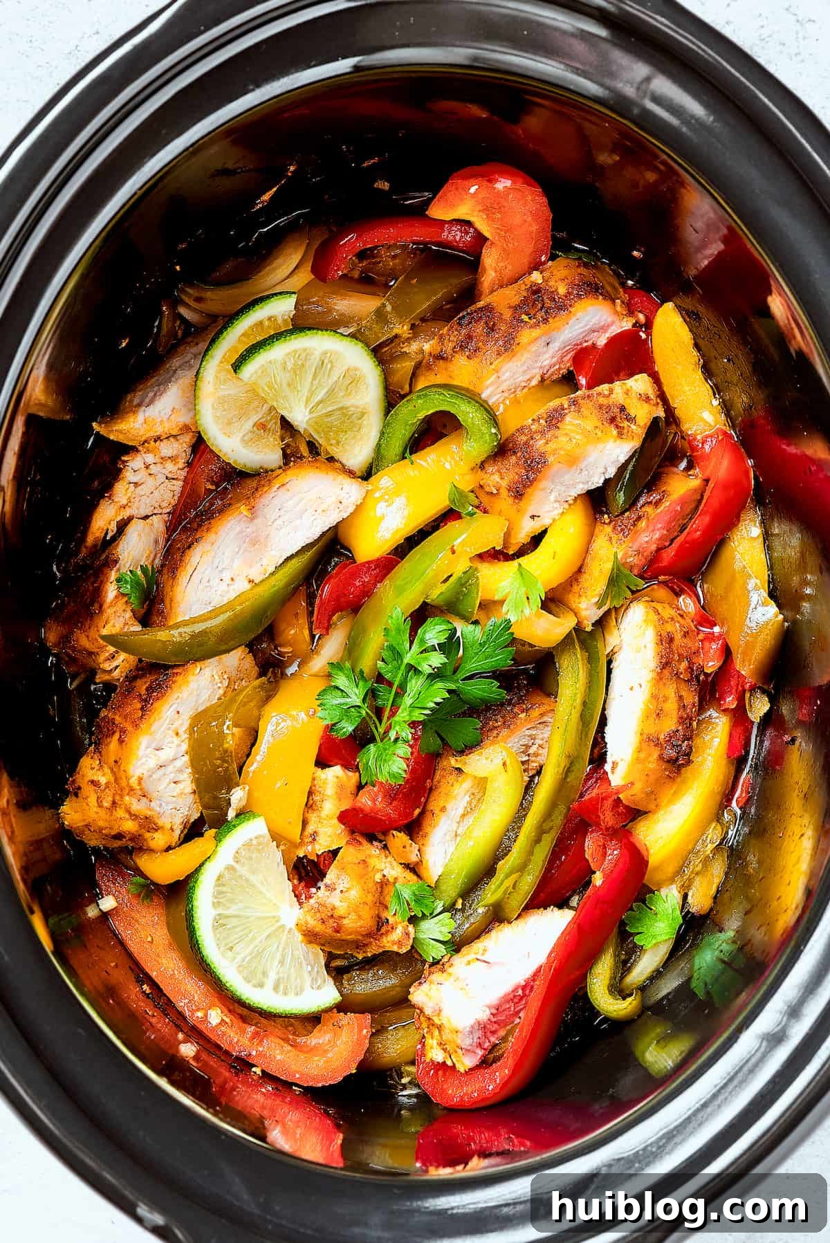 Hearty Crockpot Chicken Fajitas simmering in a slow cooker, showcasing colorful peppers and tender chicken strips.