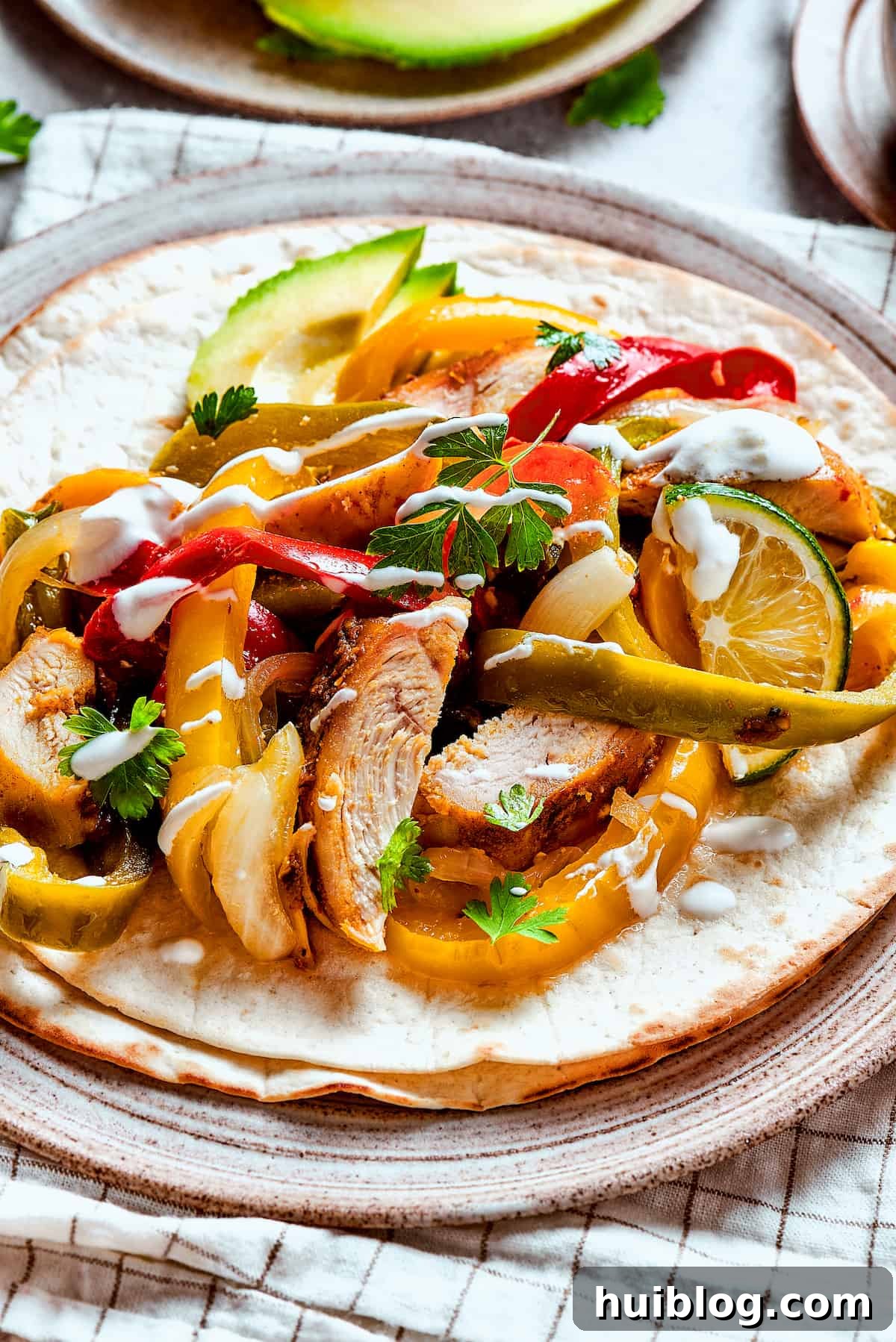 A vibrant plate of homemade chicken fajitas, garnished with fresh lime slices and bell peppers, ready to be enjoyed.