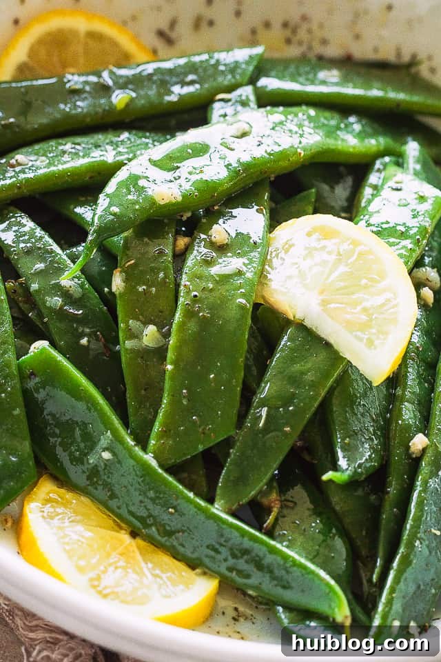 Romano Beans cooked in Garlic Butter are a delicious blend of healthy and tasty, easily prepared in no time! Close-up shot of blanched Romano Beans showing their flat, wide profile.