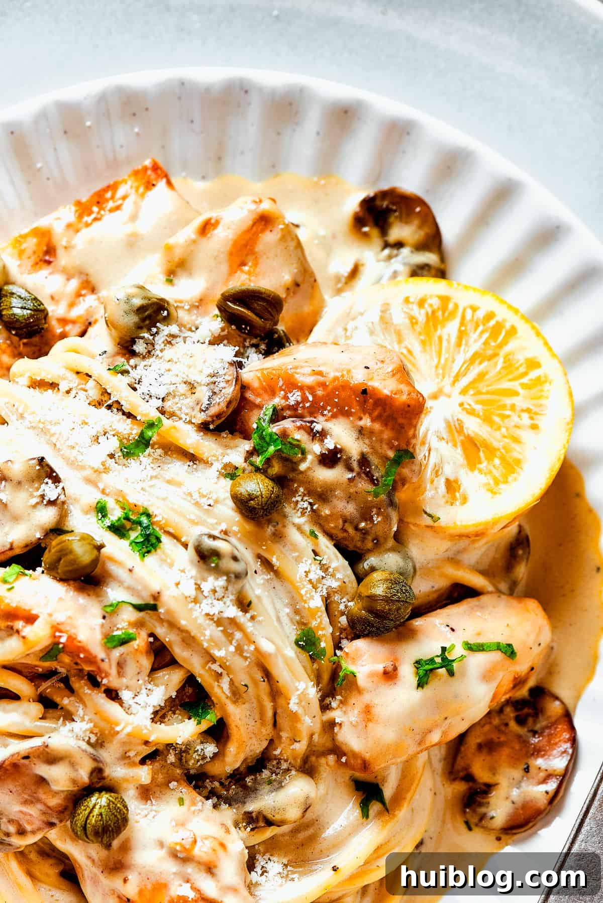 This chef’s-kiss-perfect Chicken Piccata Cheesecake Factory Copycat is loaded with juicy chicken, mushrooms, and pasta in a creamy sauce. A plate of homemade chicken piccata.