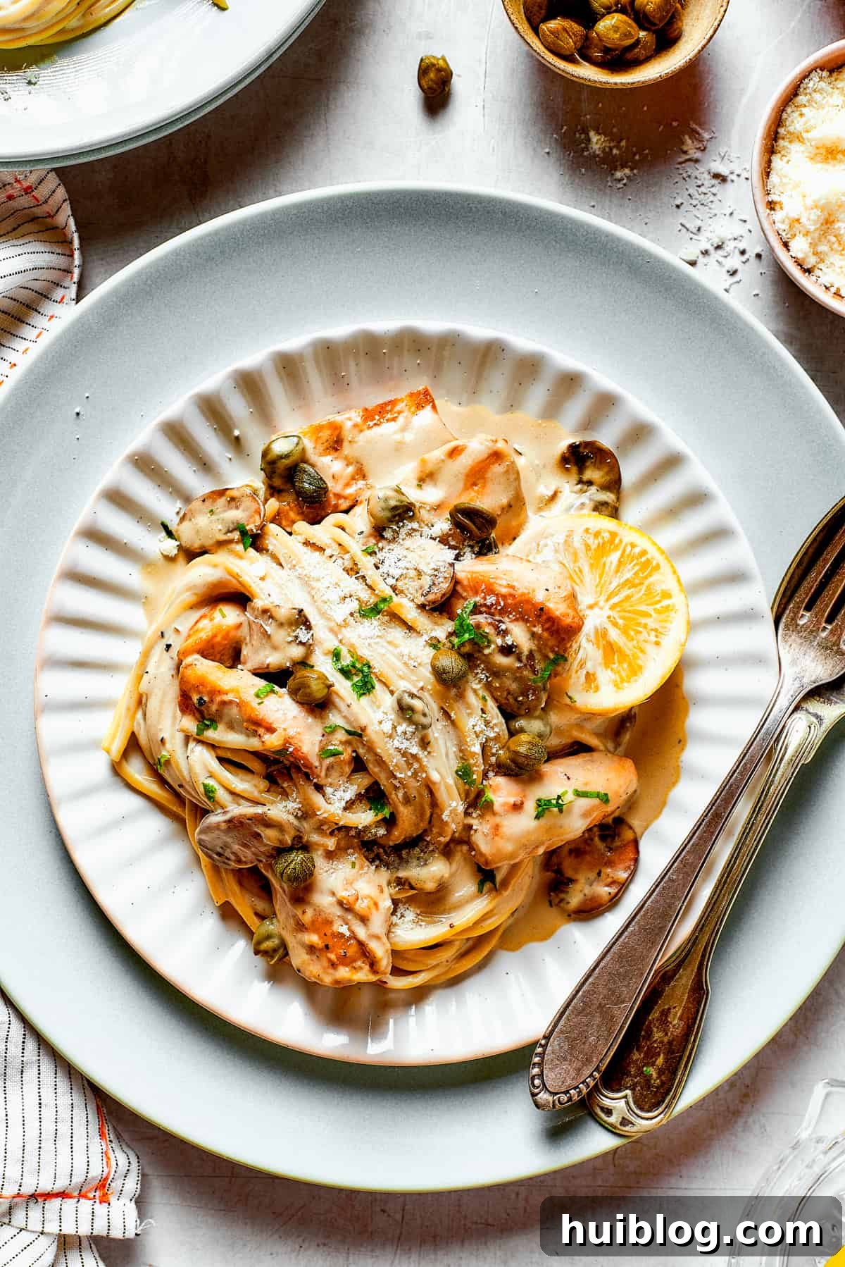 This chef’s-kiss-perfect Chicken Piccata Cheesecake Factory Copycat is loaded with juicy chicken, mushrooms, and pasta in a creamy sauce. Swirls of pasta in piccata sauce with chicken.