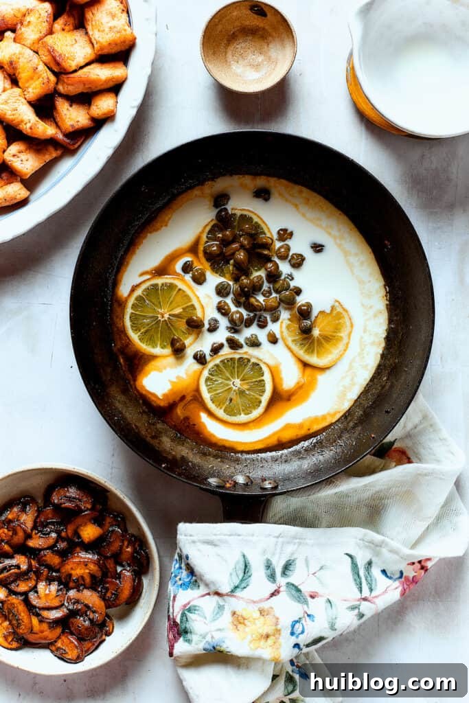 This chef’s-kiss-perfect Chicken Piccata Cheesecake Factory Copycat is loaded with juicy chicken, mushrooms, and pasta in a creamy sauce. Making a caper and lemon sauce in the skillet.