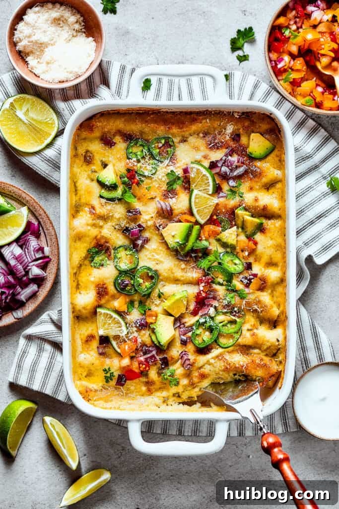 Shrimp Enchiladas are an easy, cheesy dinner with chopped shrimp and green enchilada sauce. The perfect balance of creamy, spicy, and savory! Baked shrimp enchiladas with toppings.