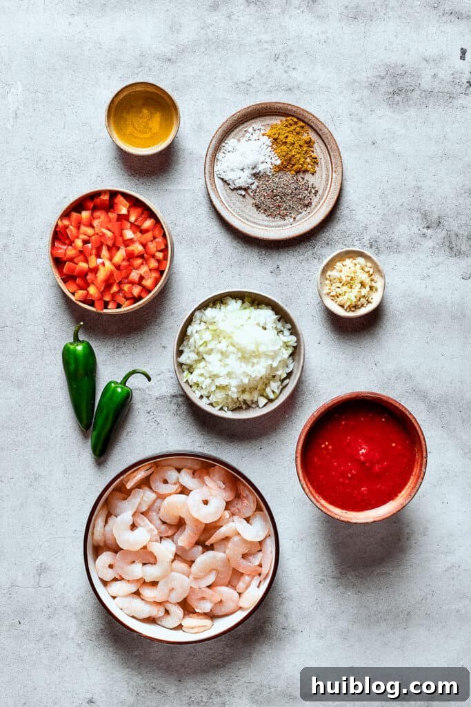 Fiesta Shrimp Enchiladas 2 Ingredients for shrimp enchilada filling measured and arranged on a work surface.