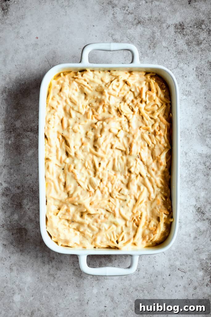 Potato mixture spread into a casserole dish.