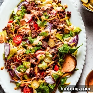 Overhead image of a Big Mac salad served on an oval white platter.