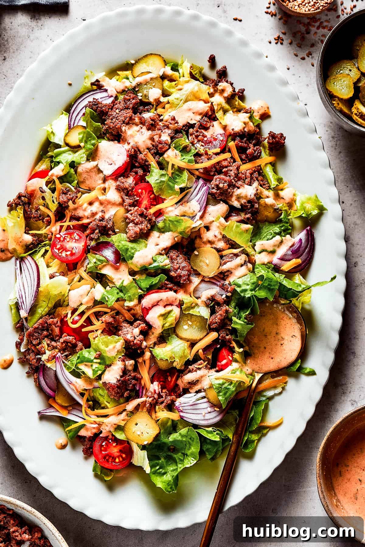 Overhead shot of a Big Mac salad on a white platter.