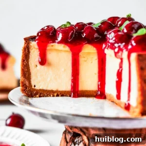 Cherry cheesecake on a cake stand.