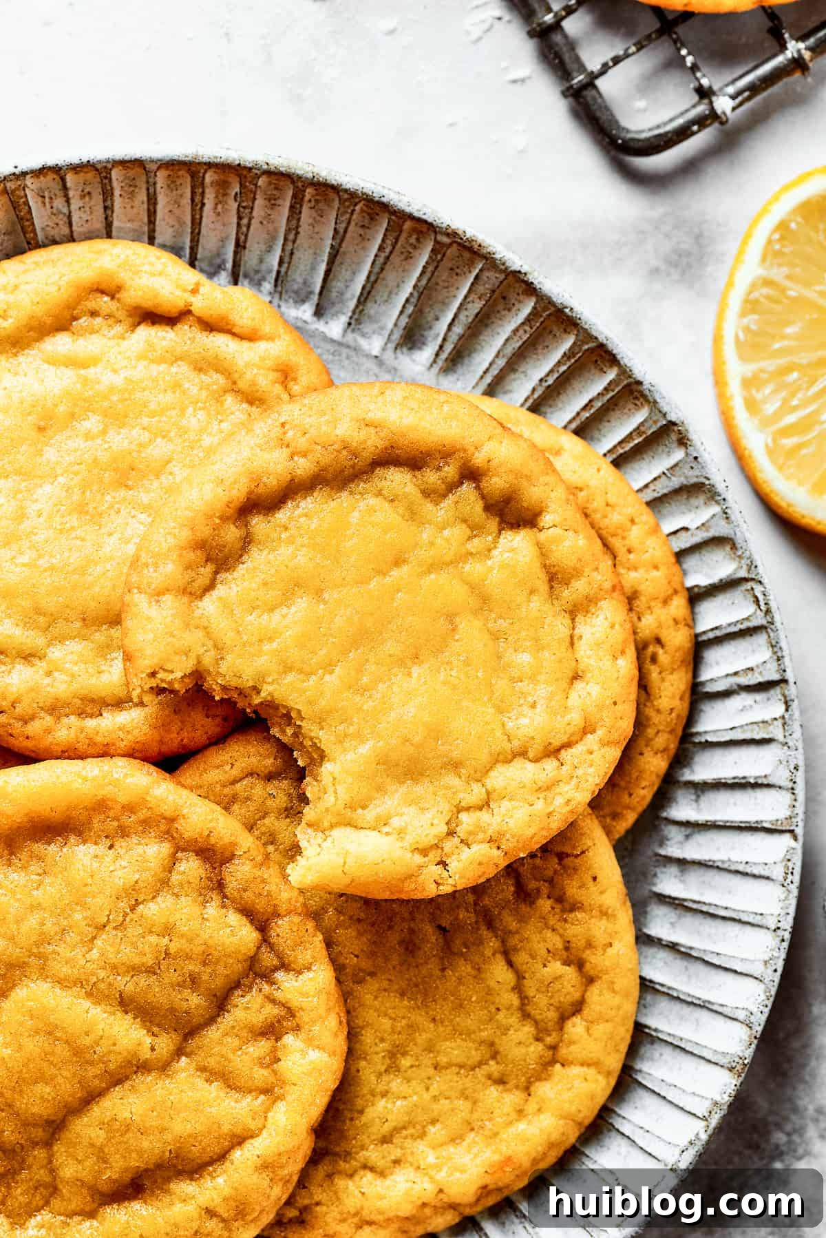 Lemon cookies are tender, soft, moist, and chewy, with tart and tangy fresh lemon flavor balanced by rich brown sugar and smooth vanilla. Cookies are served on a plate.