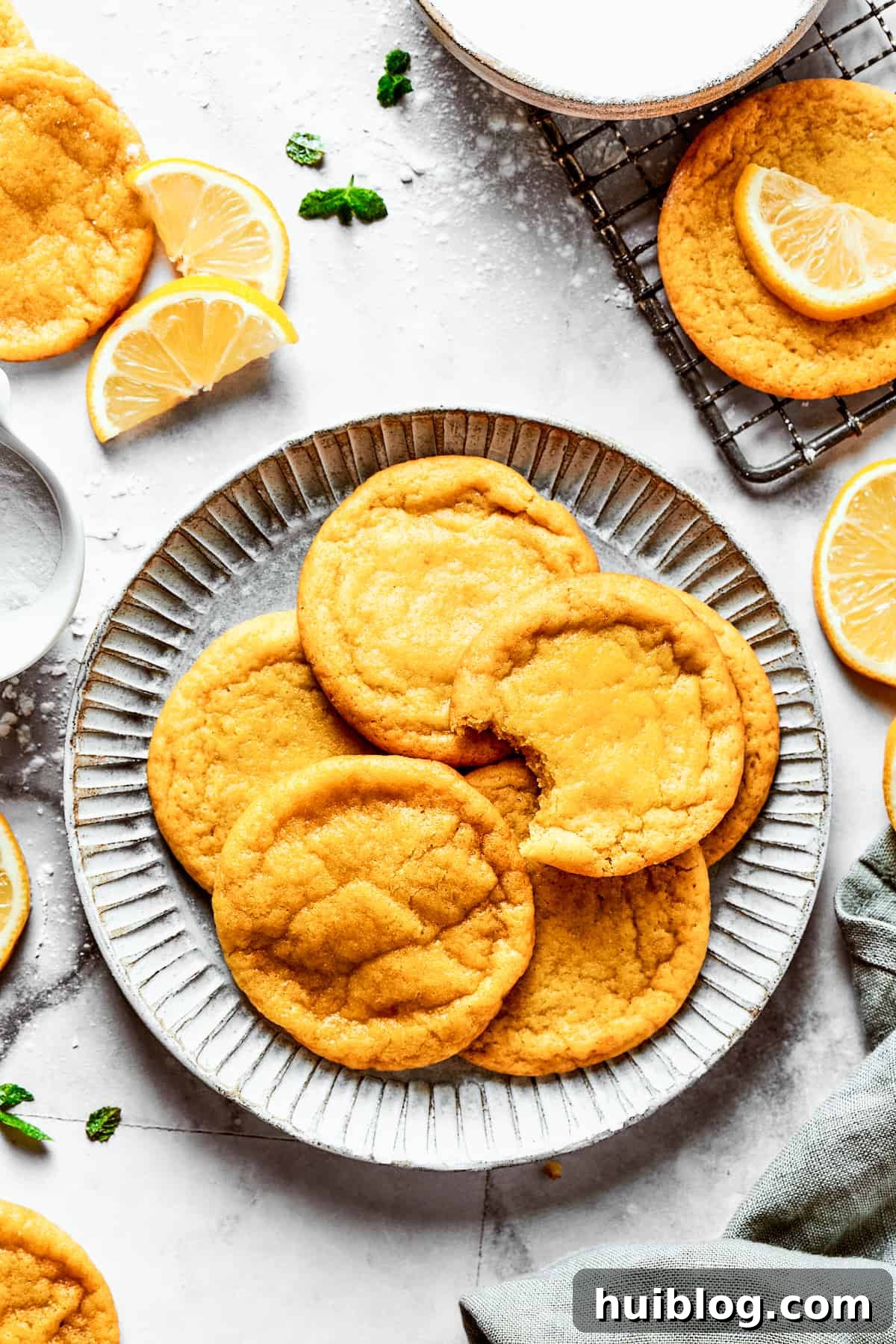 Lemon cookies are tender, soft, moist, and chewy, with tart and tangy fresh lemon flavor balanced by rich brown sugar and smooth vanilla. A plate of lemon cookies.
