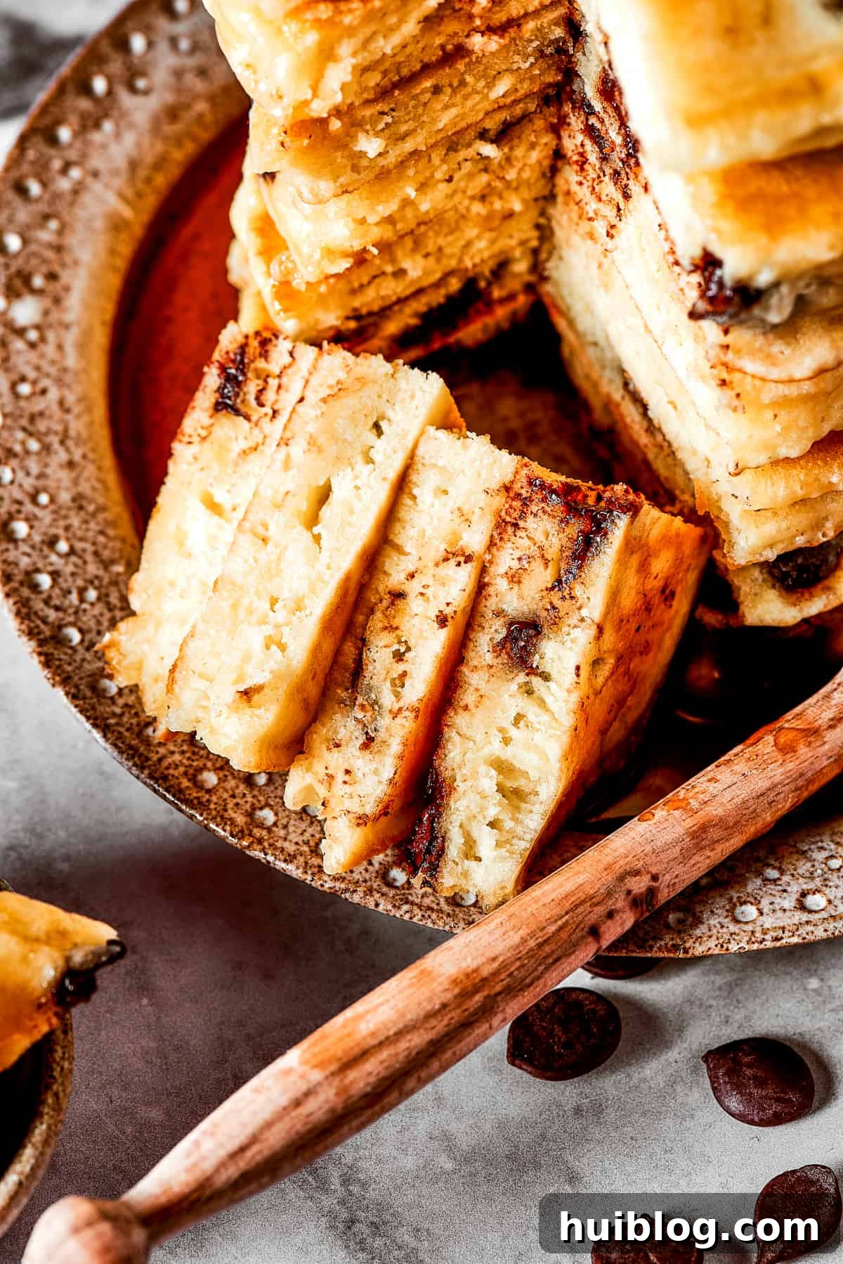 Close up of a bite of chocolate chip pancakes, showing melted chocolate.