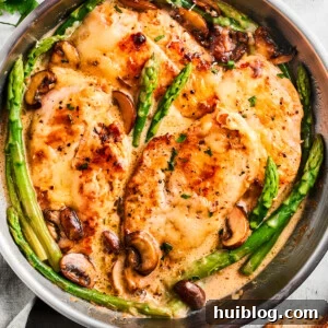 Luscious Madeira Chicken 2 Overhead image of Chicken Madeira in a skillet with asparagus spears and mushrooms.