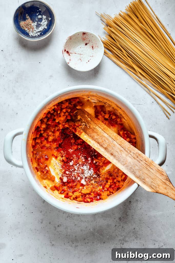 A wooden spoon stirs cooking vegetables in the soup pot, releasing their aromas.