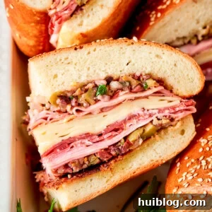 Muffaletta sandwich are shown on their sides with meat and cheese visible.