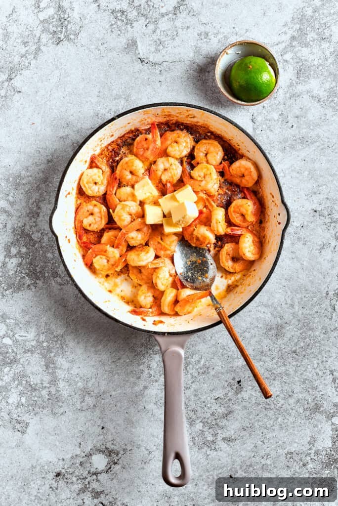 Coastal Crunch Shrimp Nachos 7 Shrimp is sauteed in a pot.