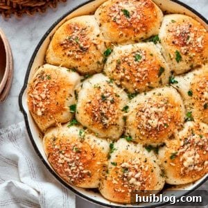 Cheesy Pizza Minis 2 A skillet of baked pizza bites next to a bowl of marinara sauce.