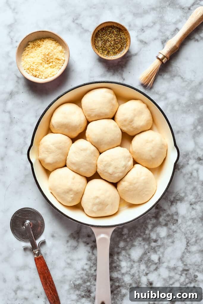 Arranging the pizza bites in a greased skillet for even baking. The 12 assembled pizza bites are carefully arranged in a skillet, ready for baking.