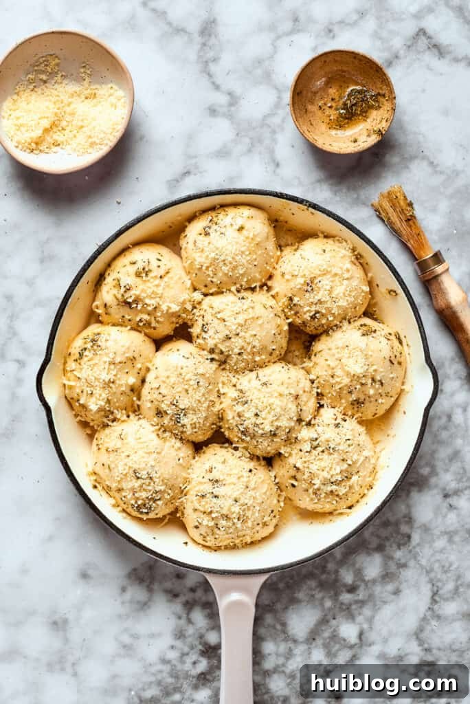 The finished assembled pizza bites, ready for the oven. Pizza bites are ready to be baked in a skillet, brushed with herb butter and topped with cheese.