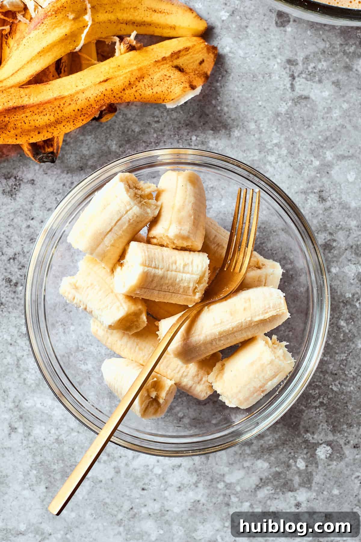A bowl filled with perfectly ripe, mashed bananas, ready to be added to the batter.