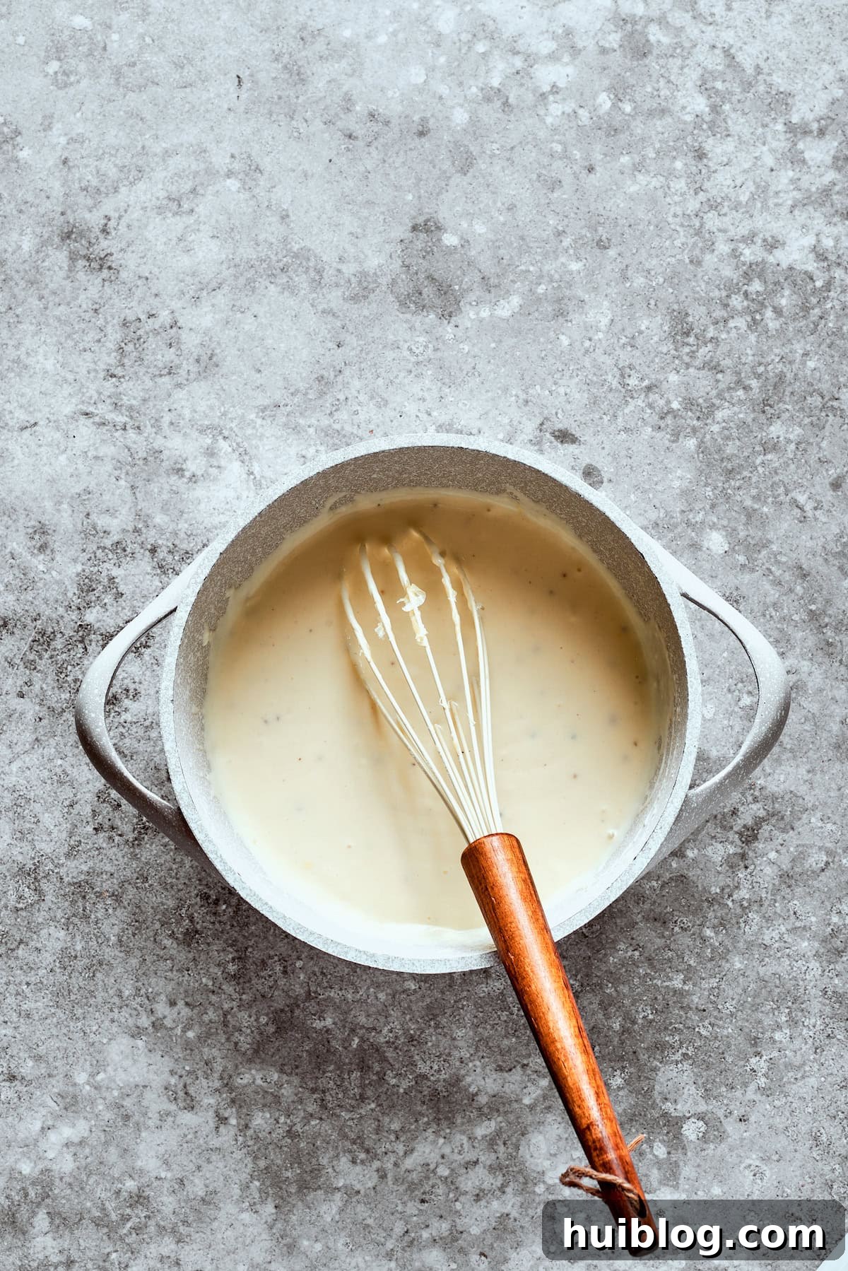 Classic Southern Fried Steak 13 A whisk blends the sauce in a bowl.