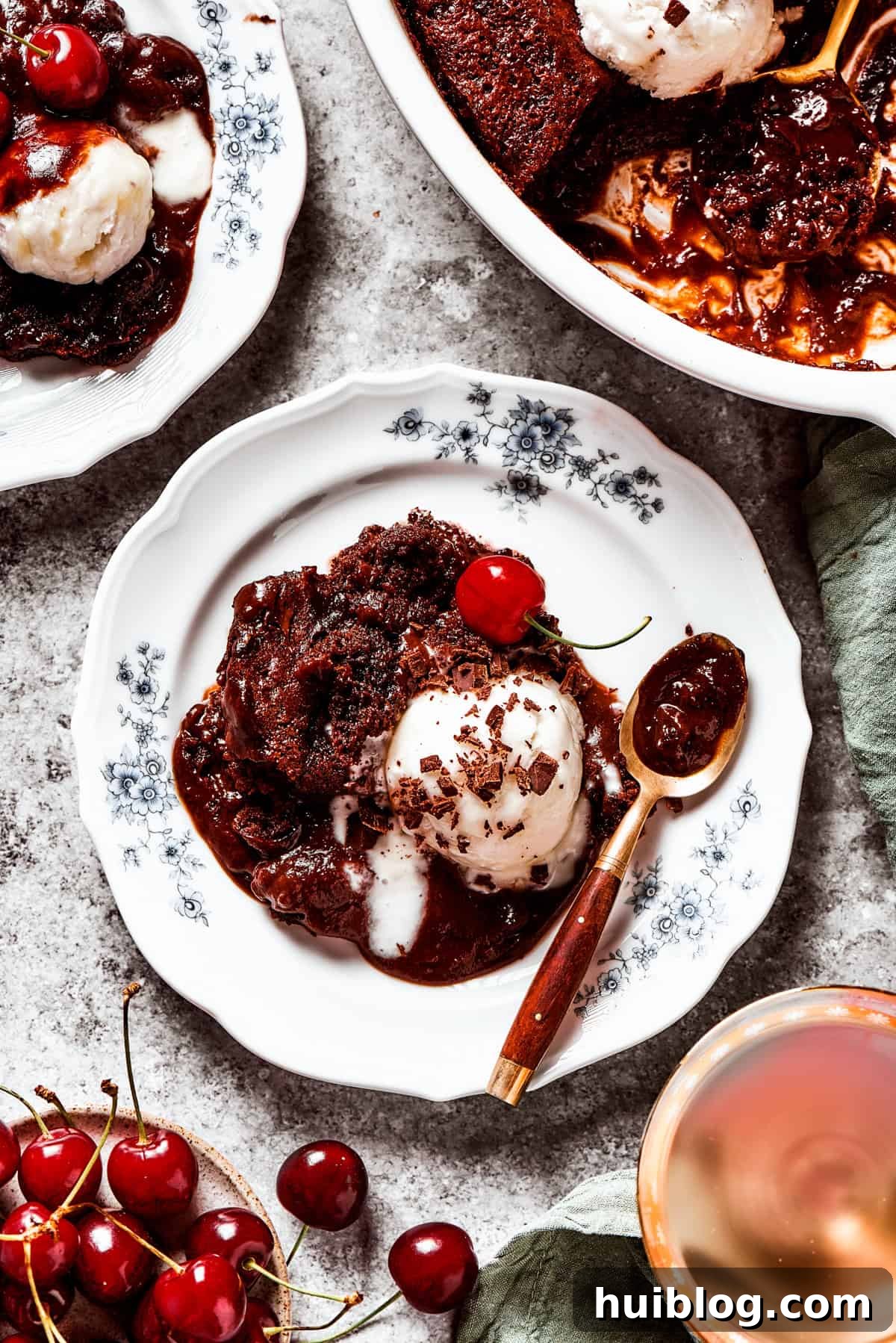 Pudding cake served on a dessert plate with a scoop of ice cream.