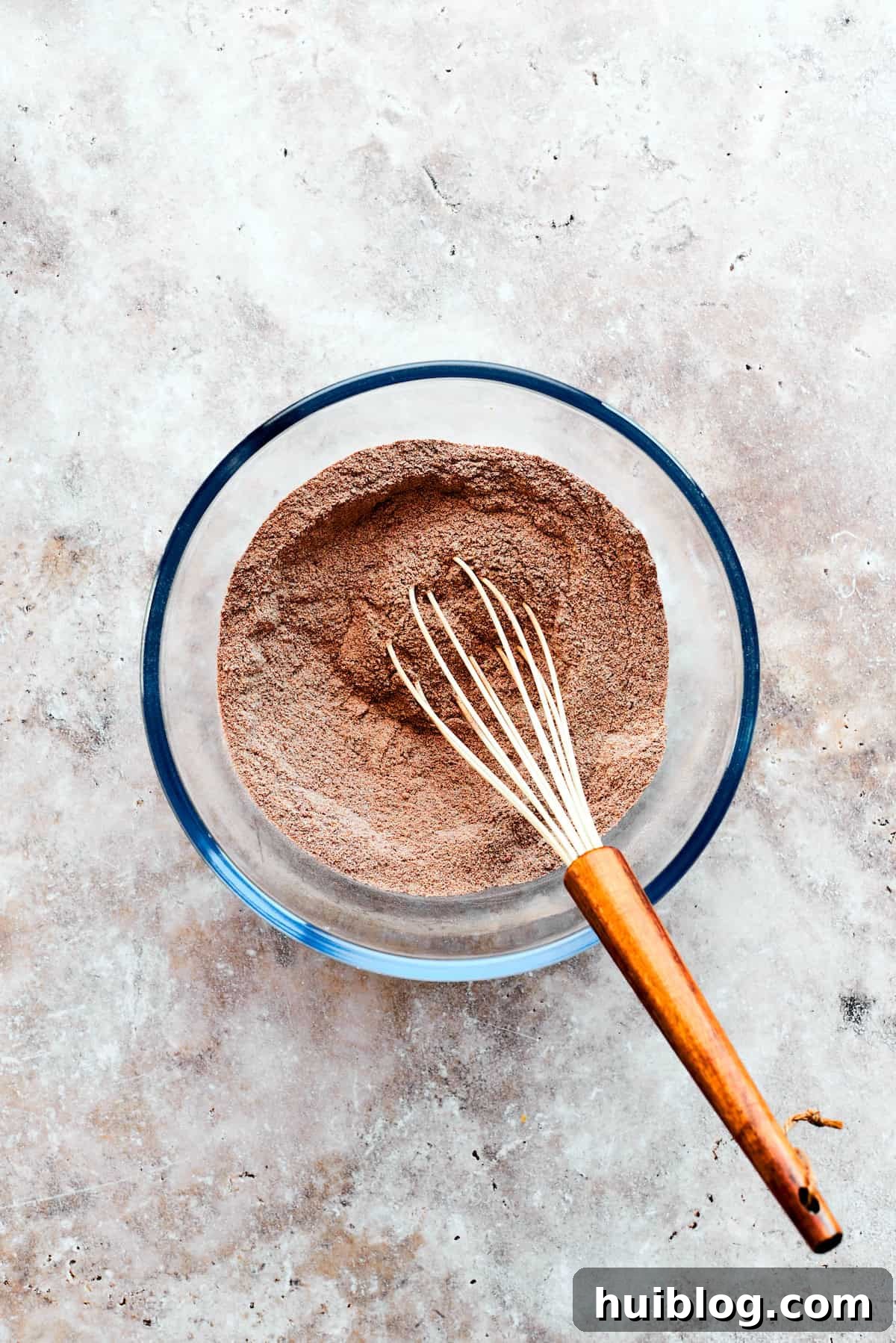 Dry ingredients for chocolate pudding cake are whisked.