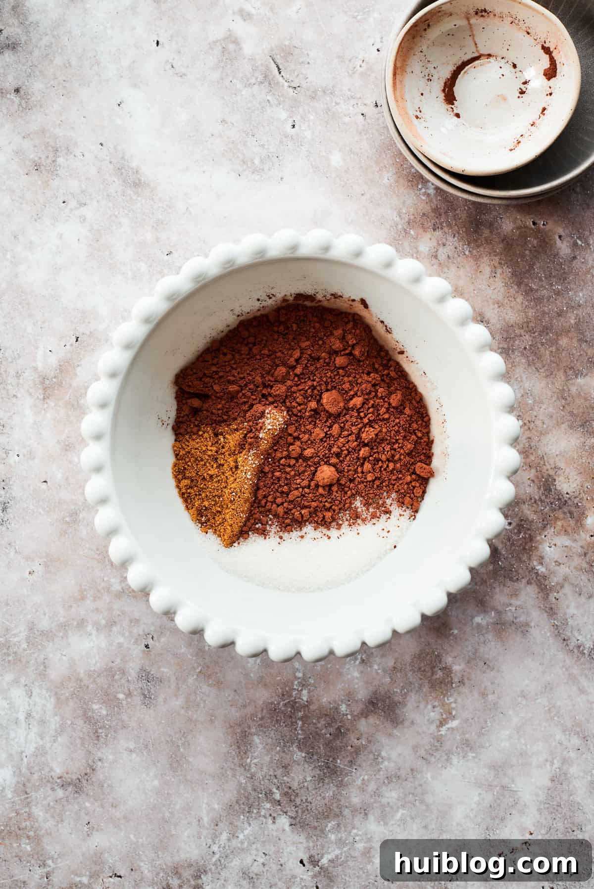 The fudge topping ingredients are added to a bowl.