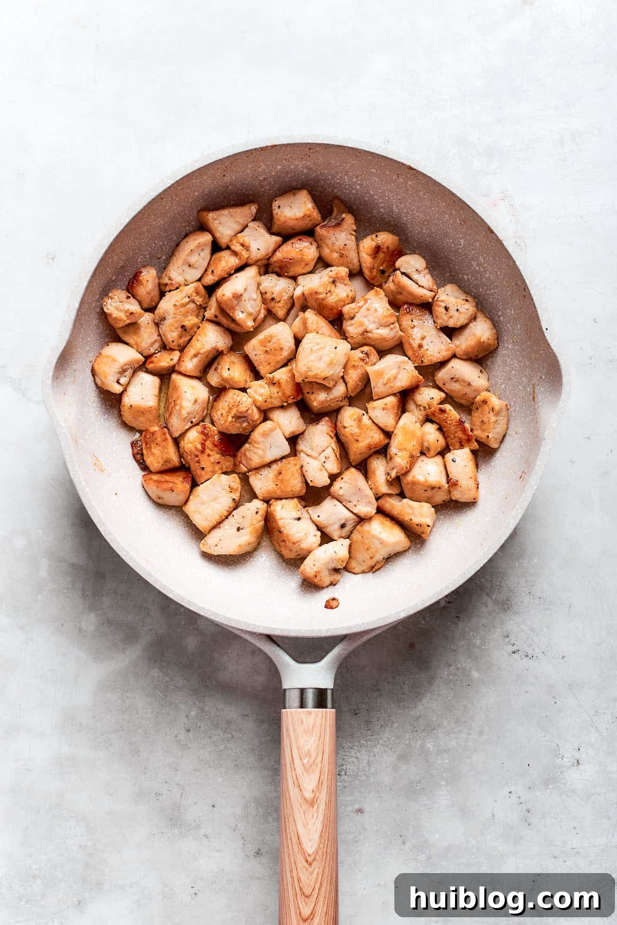 Perfectly Glazed Teriyaki Chicken 7 Chicken pieces are browned in a skillet for teriyaki chicken recipe.