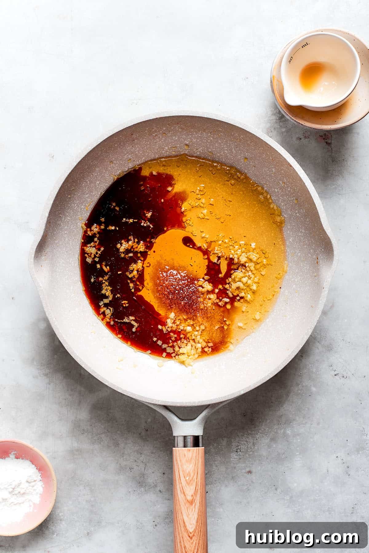 Teriyaki sauce ingredients are added to a pan.