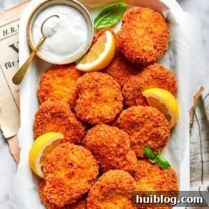 A serving tray with homemade chicken nuggets and a dish of ranch dressing and lemon slices.