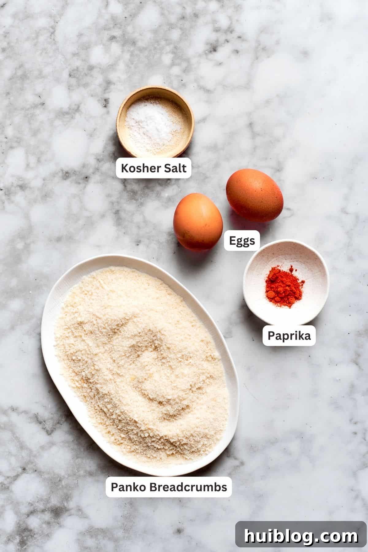 Breading ingredients for chicken nuggets recipe: panko breadcrumbs, salt, eggs, paprika, vegetable oil.
