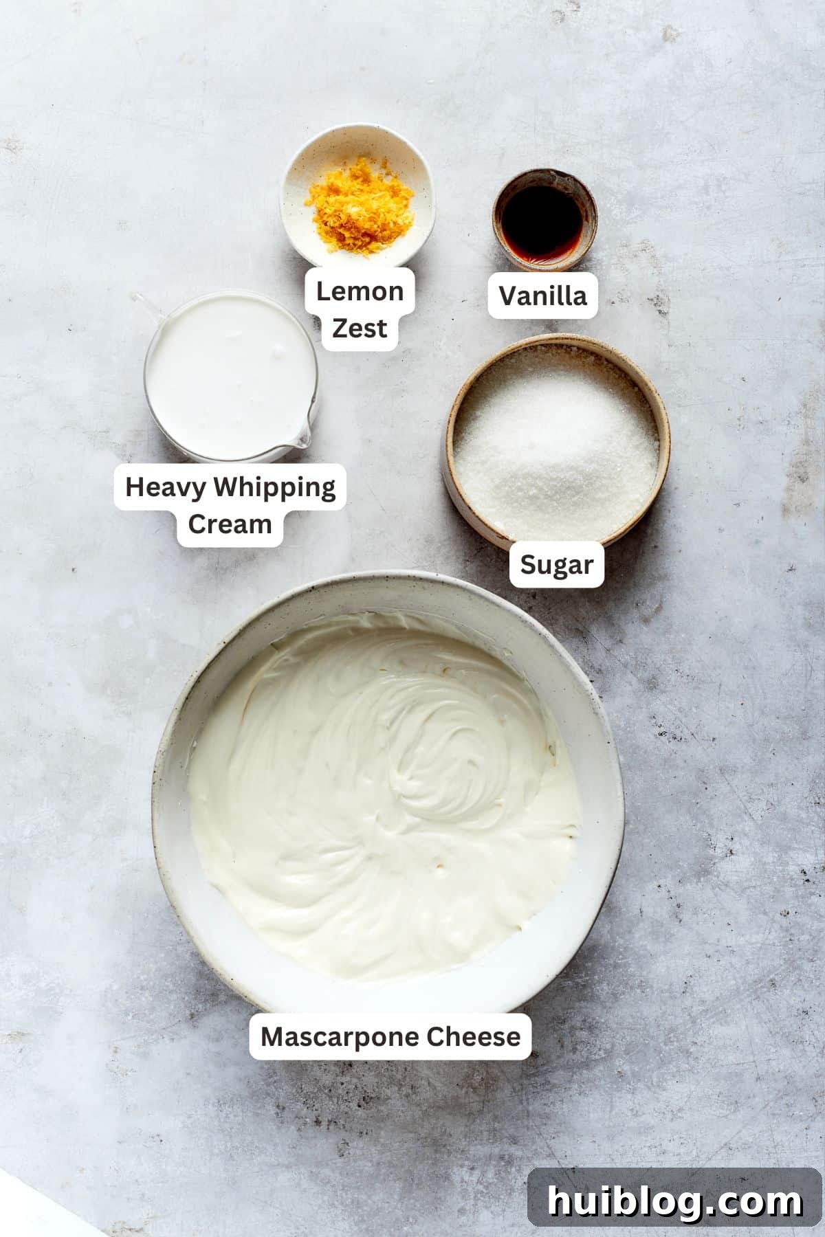 Ingredients for the lemon tiramisu filling: mascarpone cheese, granulated sugar, heavy cream, lemon zest, and vanilla extract.