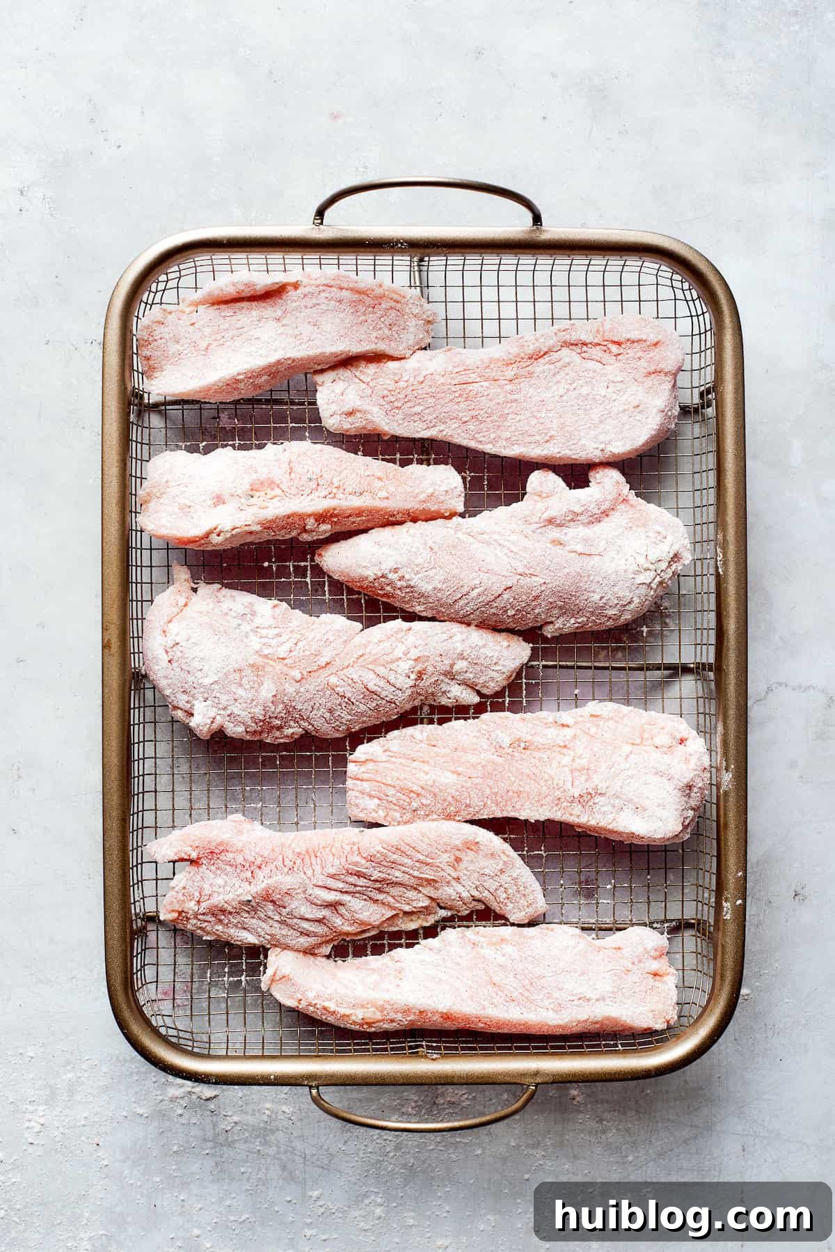 Light and crispy on the outside with a fork-tender inside, Beer Battered Chicken is an instant classic and so easy to make! Pieces of chicken on a wire rack.