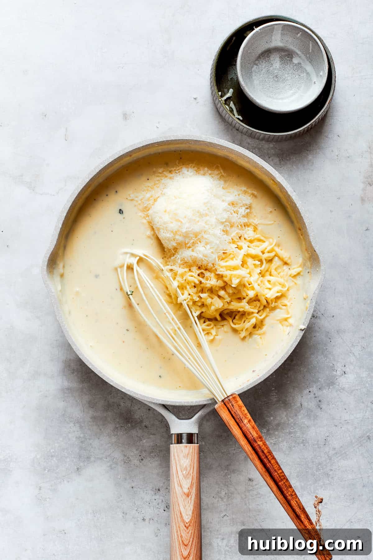 From-scratch Broccoli & Rice Casserole folds tender broccoli and fluffy white rice into a gorgeously creamy three-cheese sauce. Folding in the final selection of cheeses, including cream cheese, mozzarella, and Parmesan, into the hot sauce until fully melted and integrated.