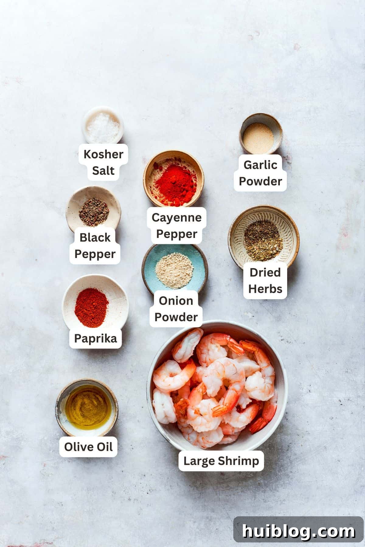 Labeled ingredients for cajun shrimp include black pepper, cayenne pepper, salt, garlic powder, dried herbs, onion powder, paprika, olive oil, shrimp.