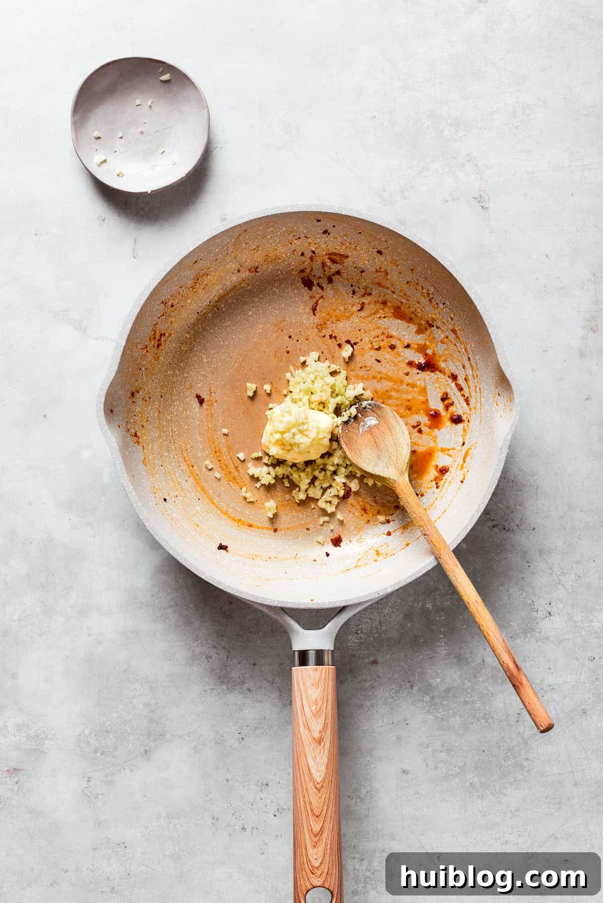 Butter is melted into a skillet with garlic.