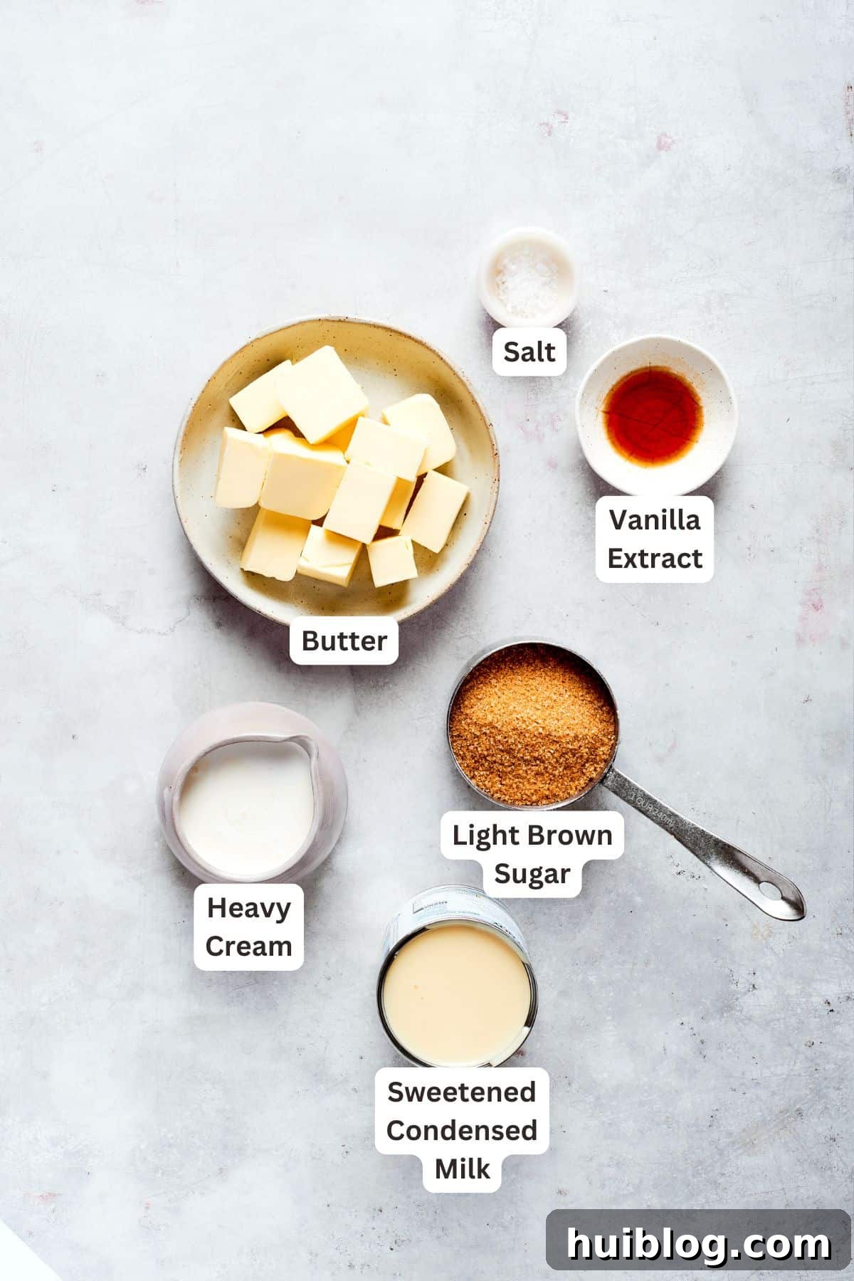 Labeled ingredients for the creamy caramel filling, featuring butter, vanilla, light brown sugar, salt, heavy cream, and sweetened condensed milk, prepared for use.