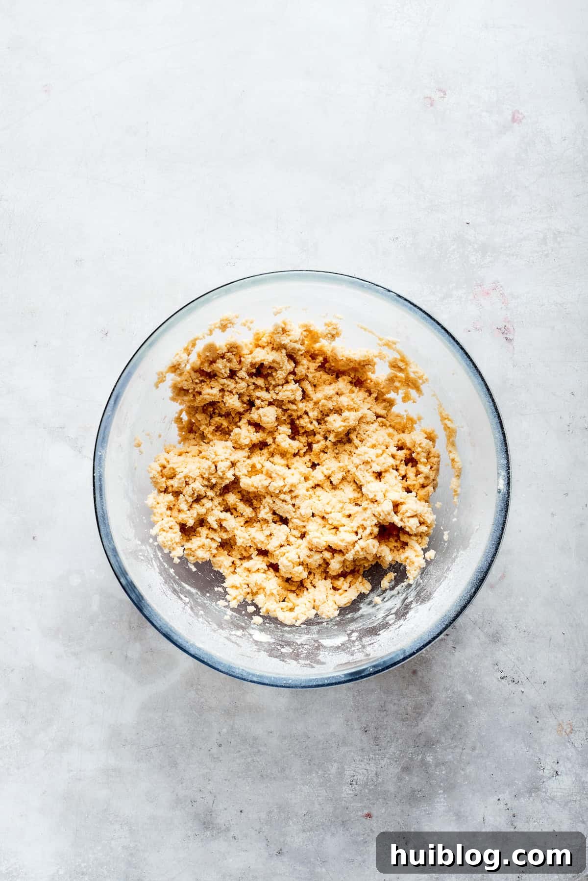 The finished shortbread dough, a smooth and cohesive ball, rests in a mixing bowl, ready for the next stage.