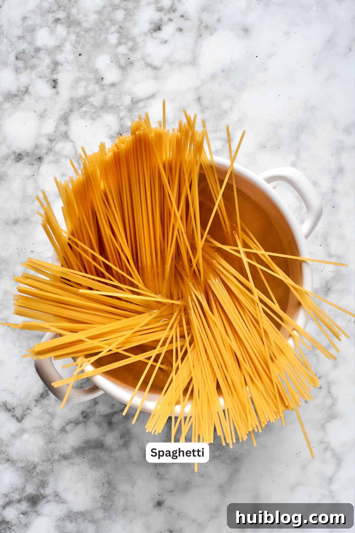 Spaghetti in a pot, ready to be cooked.