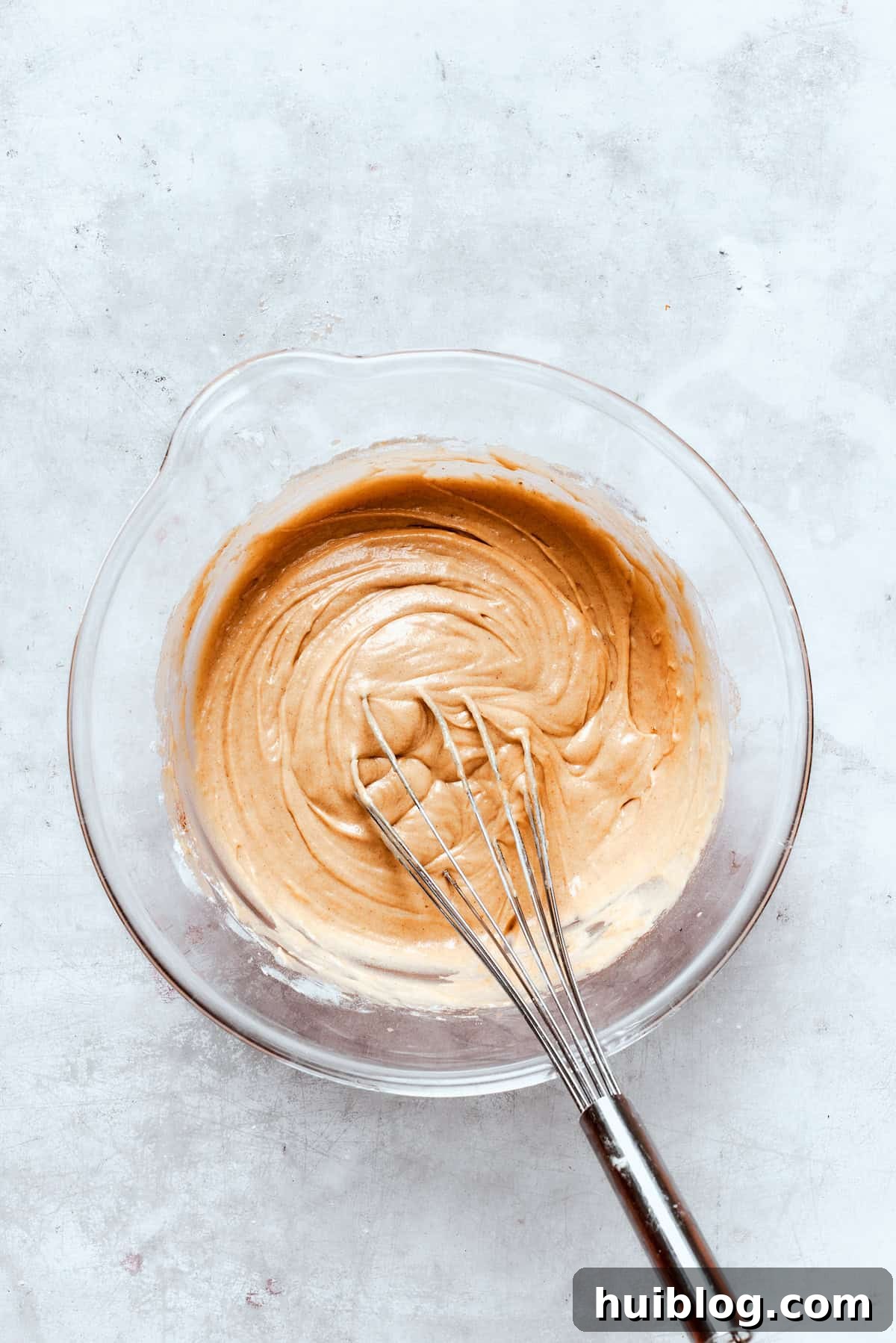 Baked not fried apple cider donuts are perfectly tender, dusted with spiced sugar, and fragrant with sweet apple cider. A bowl of apple cider donut batter is whisked until smooth, but not overmixed.