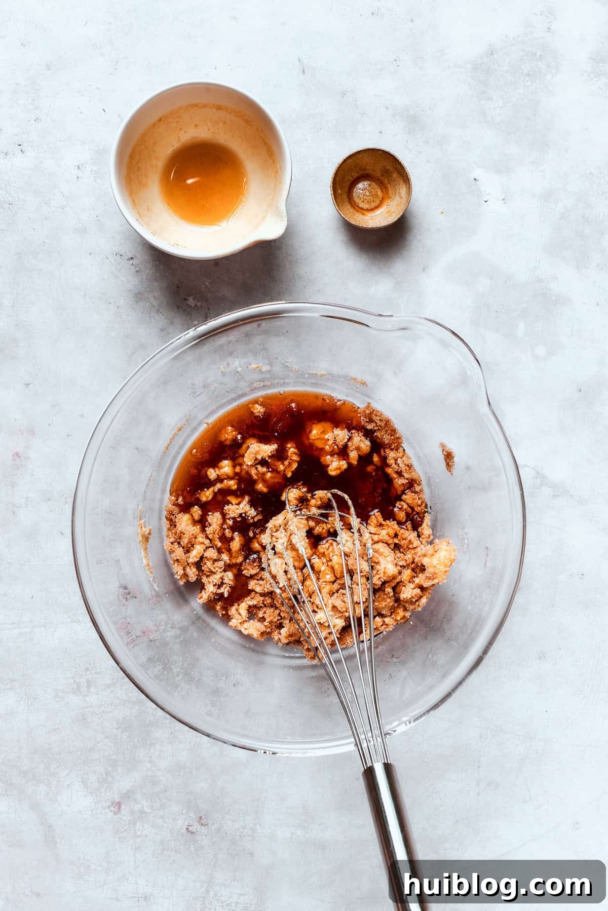 Baked not fried apple cider donuts are perfectly tender, dusted with spiced sugar, and fragrant with sweet apple cider. Vanilla extract is poured into the butter and sugar mixture, ready to be combined.