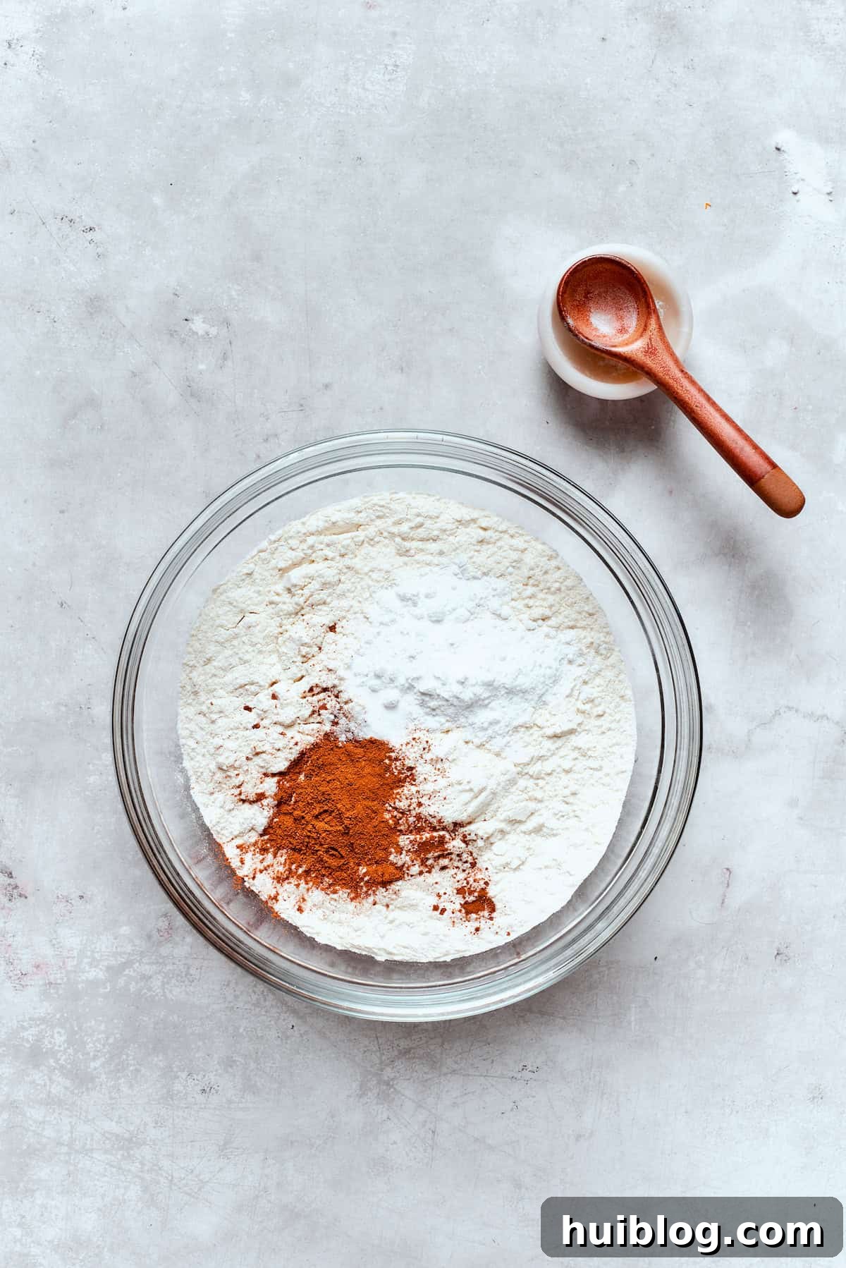 Baked not fried apple cider donuts are perfectly tender, dusted with spiced sugar, and fragrant with sweet apple cider. All-purpose flour, baking powder, baking soda, salt, and various ground spices are combined in a separate bowl.