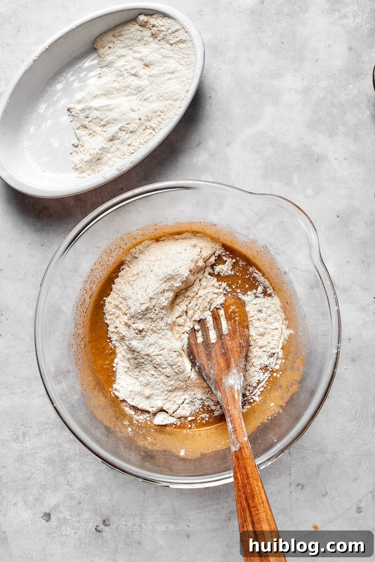 The whisked dry ingredients are gently folded into the wet cookie dough mixture, ensuring even incorporation.