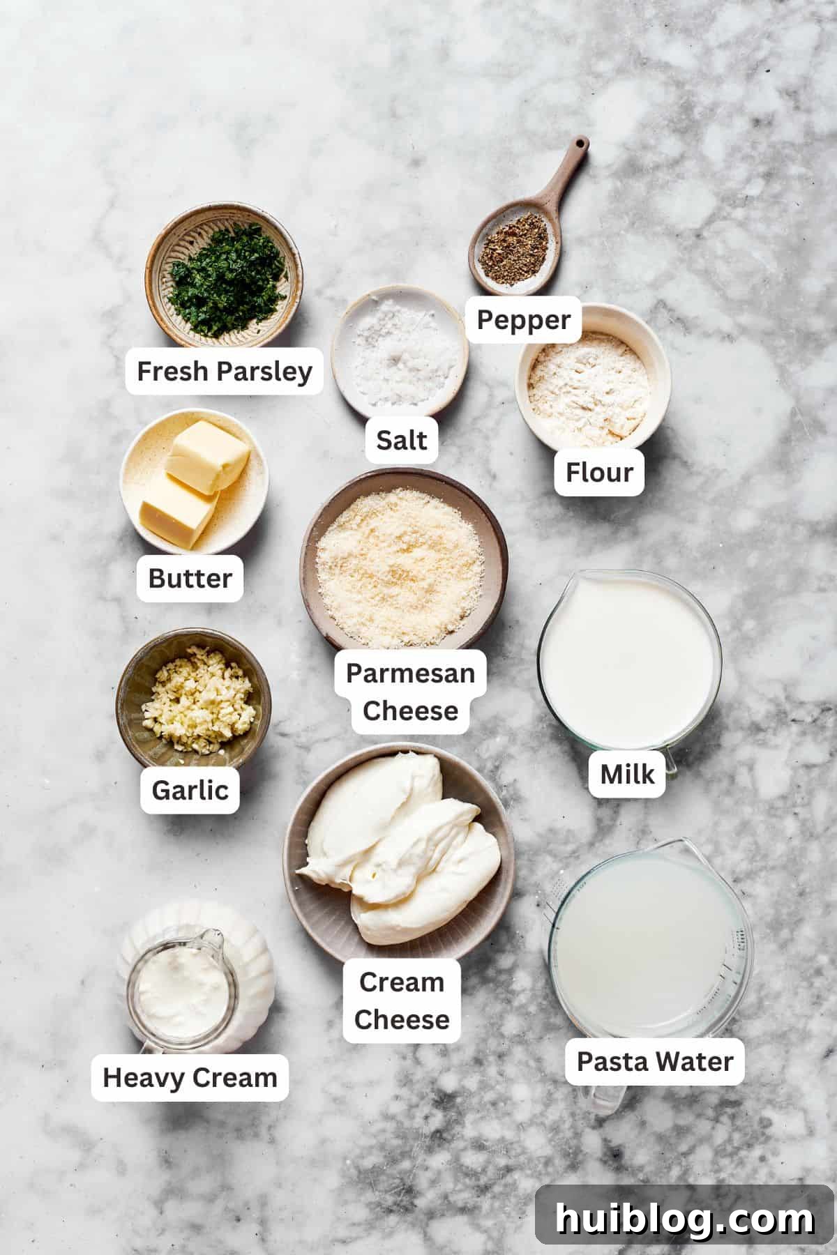 Garlic Parmesan Sauce Ingredients Essential ingredients for the rich garlic parmesan sauce, including unsalted butter, minced garlic, all-purpose flour, milk, heavy cream, shredded Parmesan, and cream cheese.