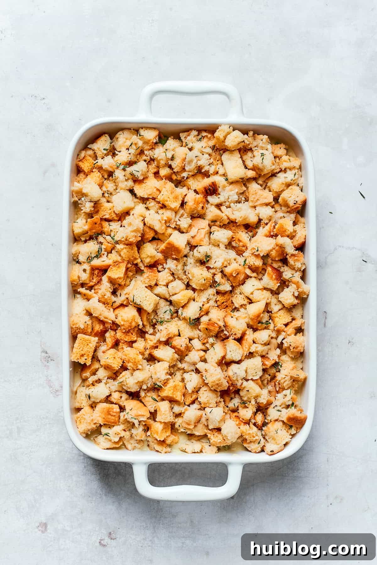 This chicken stuffing casserole features tender chicken filling with veggies topped with classic stuffing. An easy recipe baked until golden! Adding a layer of prepared stuffing over the chicken filling in the baking dish.