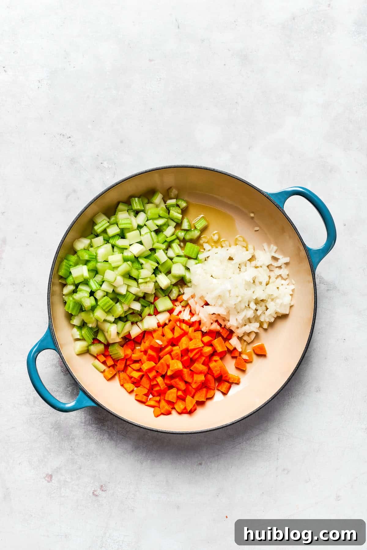 This chicken stuffing casserole features tender chicken filling with veggies topped with classic stuffing. An easy recipe baked until golden! Sautéing diced onions, carrots, and celery in a pot.