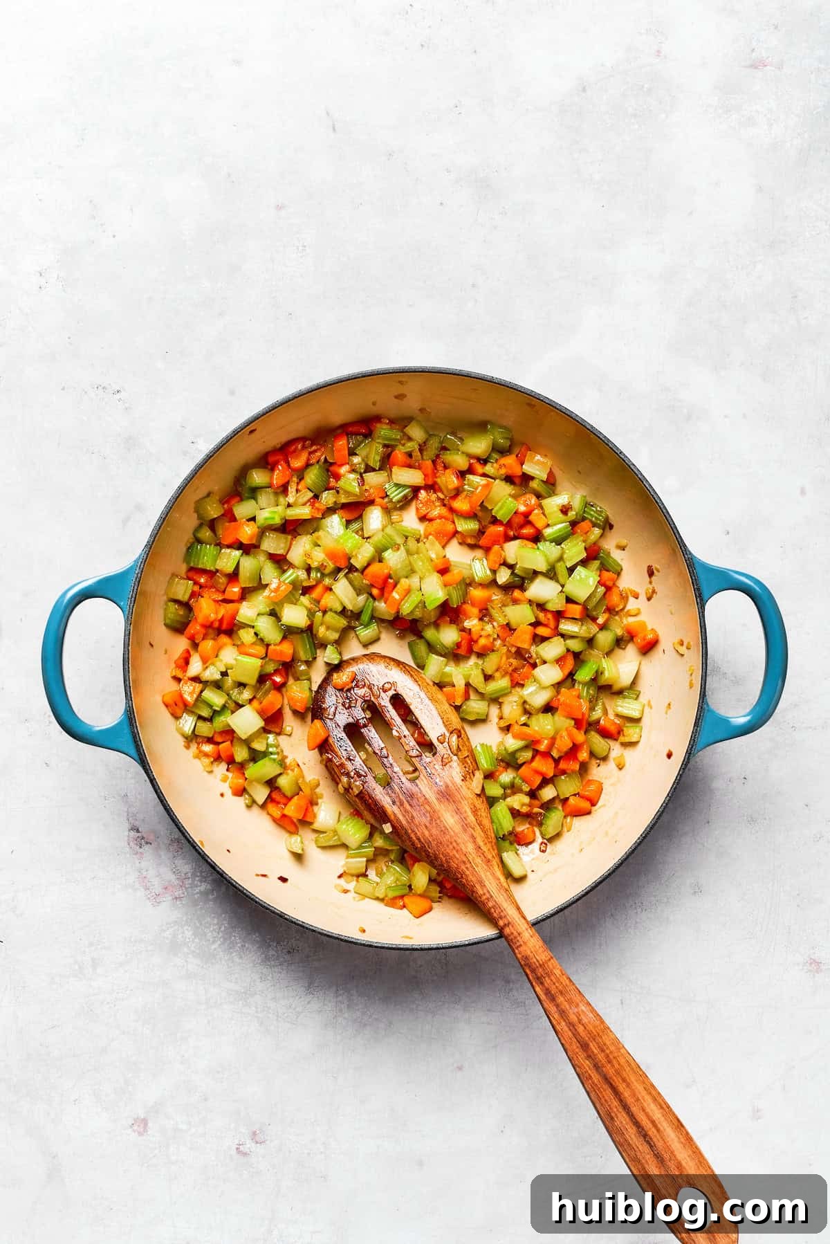 This chicken stuffing casserole features tender chicken filling with veggies topped with classic stuffing. An easy recipe baked until golden! Close-up of cooked and softened vegetables in a pot.