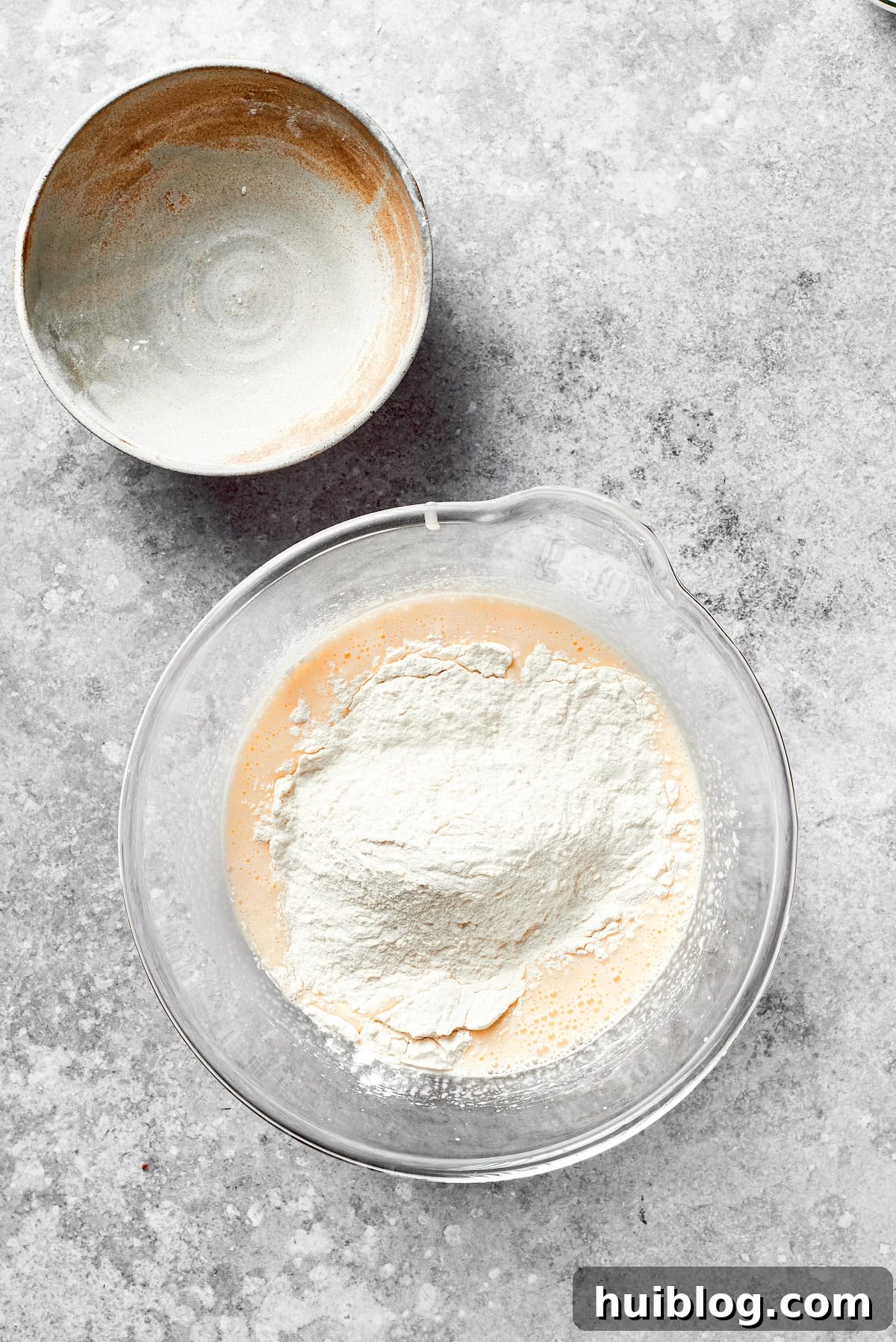 Dry ingredients are gently folded into the wet cake batter.